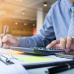 Business finance man calculating budget numbers, Invoices and fi